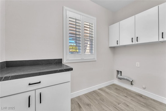 10345 Howling Coyote Ave, Las Vegas, NV 89135 - clothes washing area featuring gas dryer hookup, cabinet space, baseboards, light wood-style floors, and hookup for an electric dryer