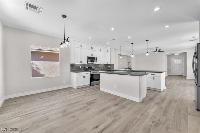 10345 Howling Coyote Ave, Las Vegas, NV 89135 - kitchen with stainless steel appliances, dark countertops, backsplash, recessed lighting, and baseboards