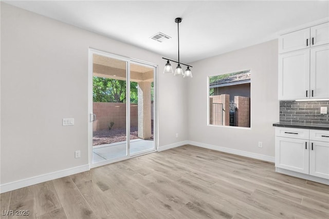 10345 Howling Coyote Ave, Las Vegas, NV 89135 - unfurnished dining area featuring light wood finished floors and baseboards