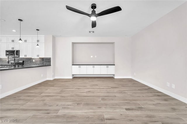 10345 Howling Coyote Ave, Las Vegas, NV 89135 - unfurnished living room with a ceiling fan, light wood-style floors, recessed lighting, and baseboards