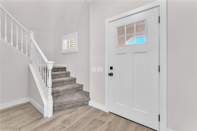 10345 Howling Coyote Ave, Las Vegas, NV 89135 - foyer featuring healthy amount of natural light, light wood finished floors, stairway, and baseboards