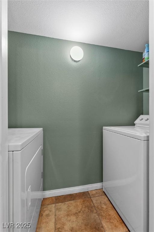 231 W Horizon Ridge Parkway Unit 1228, Henderson, NV 89012 - clothes washing area featuring separate washer and dryer, tile patterned flooring, a textured ceiling, and baseboards