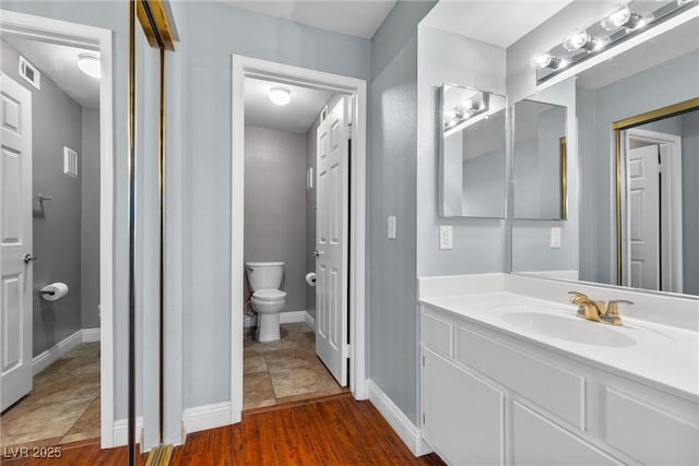 231 W Horizon Ridge Parkway Unit 1228, Henderson, NV 89012 - bathroom featuring toilet, vanity, and baseboards