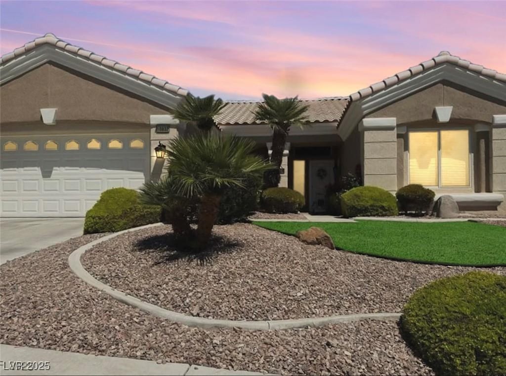 10832 Heritage Hills Dr, Las Vegas, NV 89134 - ranch-style home featuring driveway, a tile roof, a garage, and stucco siding