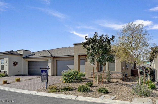 9903 Spinel Pl, Las Vegas, NV 89143 - view of front facade with a garage, stucco siding, and driveway