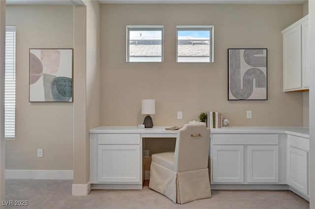 9903 Spinel Pl, Las Vegas, NV 89143 - home office with light colored carpet, built in study area, and baseboards