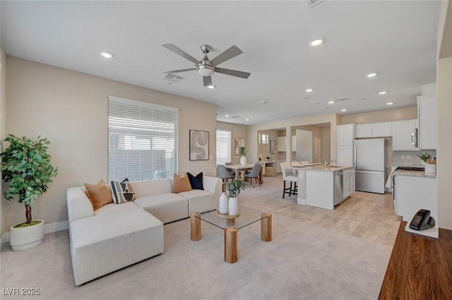 9903 Spinel Pl, Las Vegas, NV 89143 - living room featuring ceiling fan, light colored carpet, recessed lighting, and baseboards