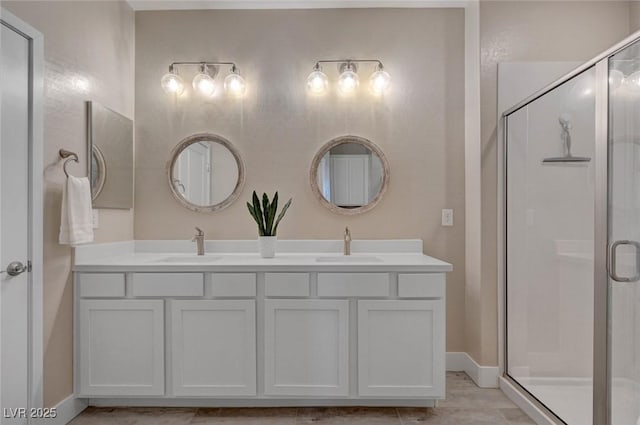 9903 Spinel Pl, Las Vegas, NV 89143 - full bathroom featuring double vanity, a stall shower, and baseboards
