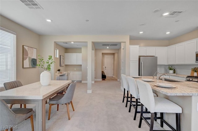 9903 Spinel Pl, Las Vegas, NV 89143 - dining space with light colored carpet, recessed lighting, and baseboards