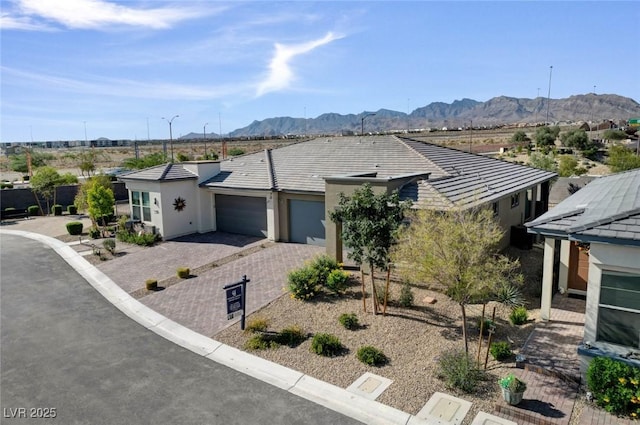 9903 Spinel Pl, Las Vegas, NV 89143 - ranch-style home with a garage, stucco siding, a mountain view, and driveway