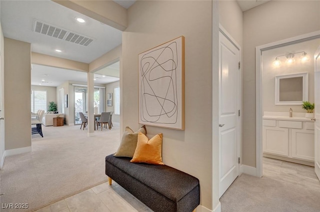 9903 Spinel Pl, Las Vegas, NV 89143 - corridor with light colored carpet, a sink, recessed lighting, and baseboards