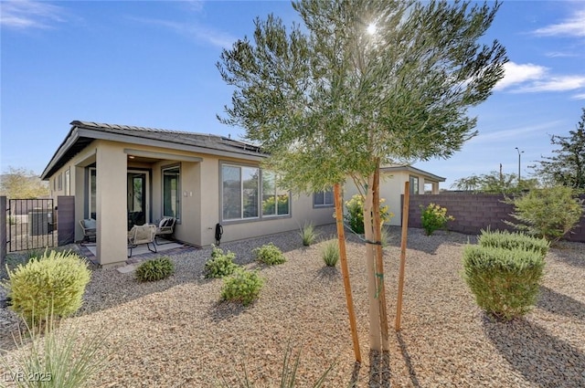 9903 Spinel Pl, Las Vegas, NV 89143 - view of front of property with stucco siding, a patio area, and solar panels