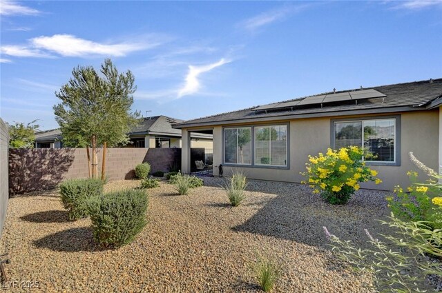 9903 Spinel Pl, Las Vegas, NV 89143 - rear view of property featuring stucco siding and solar panels