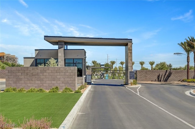 9903 Spinel Pl, Las Vegas, NV 89143 - view of asphalt road with a gate, curbs, and a gated entry