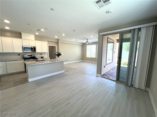 9903 Spinel Pl, Las Vegas, NV 89143 - kitchen with appliances with stainless steel finishes, baseboards, light wood-style flooring, recessed lighting, and open floor plan