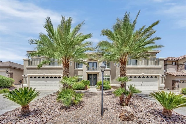 9046 Barium Rock Ave, Las Vegas, NV 89143 - view of front of home featuring a garage, driveway, stucco siding, and a balcony