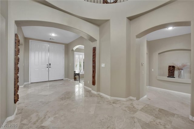 9046 Barium Rock Ave, Las Vegas, NV 89143 - foyer entrance with arched walkways, light marble finish floors, and baseboards