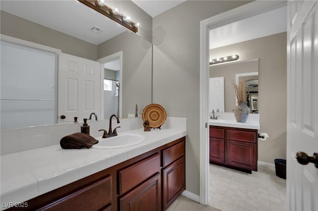 9046 Barium Rock Ave, Las Vegas, NV 89143 - bathroom with two vanities and baseboards