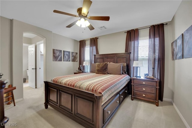 9046 Barium Rock Ave, Las Vegas, NV 89143 - bedroom with light colored carpet, arched walkways, baseboards, and ceiling fan
