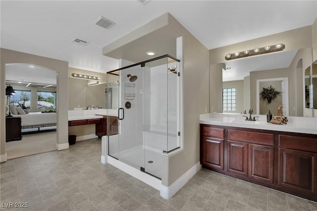 9046 Barium Rock Ave, Las Vegas, NV 89143 - bathroom with baseboards, connected bathroom, healthy amount of natural light, and a stall shower