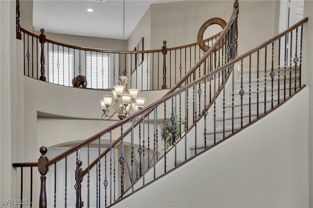 9046 Barium Rock Ave, Las Vegas, NV 89143 - stairway featuring a chandelier, a towering ceiling, and recessed lighting