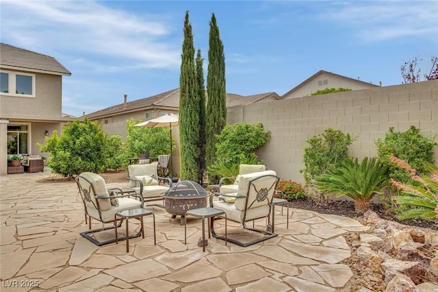 9046 Barium Rock Ave, Las Vegas, NV 89143 - view of patio / terrace featuring an outdoor fire pit and fence