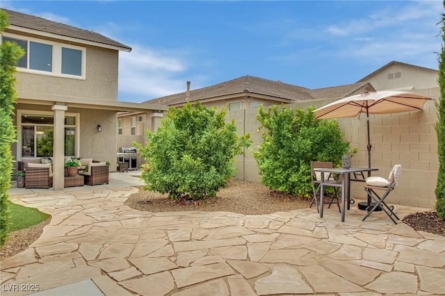9046 Barium Rock Ave, Las Vegas, NV 89143 - view of patio with an outdoor living space, fence, area for grilling, and outdoor dining area