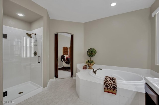 9046 Barium Rock Ave, Las Vegas, NV 89143 - full bath with a stall shower, a garden tub, tile patterned flooring, recessed lighting, and baseboards