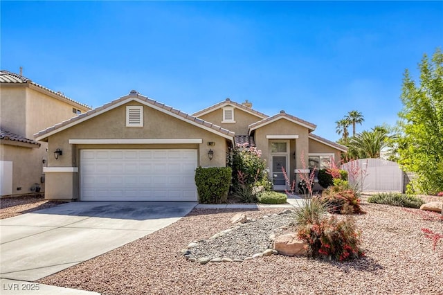 6021 Winter Meadow St, Las Vegas, NV 89130 - view of front of house featuring stucco siding, driveway, a garage, and a tile roof