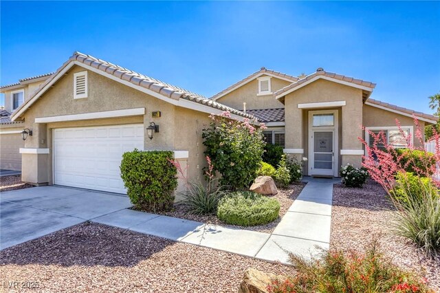 6021 Winter Meadow St, Las Vegas, NV 89130 - view of property featuring a garage, stucco siding, and concrete driveway