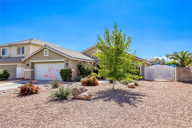 6021 Winter Meadow St, Las Vegas, NV 89130 - view of front facade with a gate, stucco siding, driveway, fence, and an attached garage
