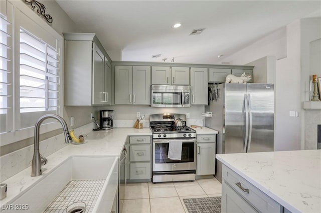 6021 Winter Meadow St, Las Vegas, NV 89130 - kitchen featuring appliances with stainless steel finishes, a sink, gray cabinets, light tile patterned flooring, and recessed lighting