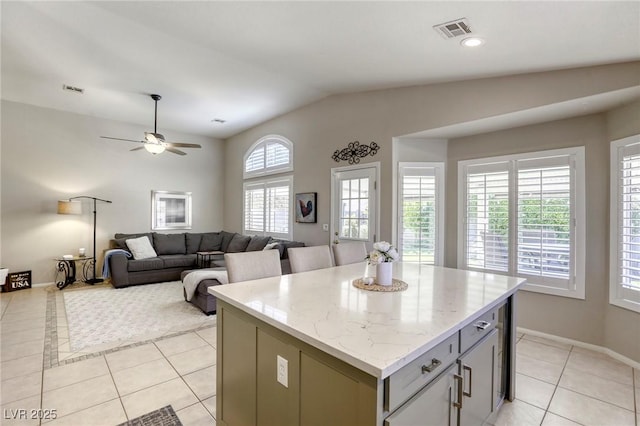 6021 Winter Meadow St, Las Vegas, NV 89130 - kitchen featuring light tile patterned flooring, a kitchen island, gray cabinetry, lofted ceiling, and a ceiling fan