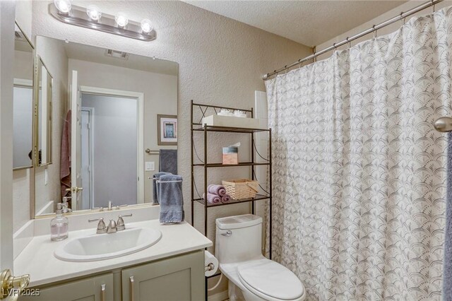 6021 Winter Meadow St, Las Vegas, NV 89130 - bathroom with a textured wall, toilet, a textured ceiling, vanity, and a shower with curtain