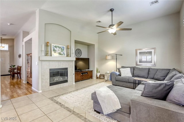 6021 Winter Meadow St, Las Vegas, NV 89130 - tiled living area with a ceiling fan, a fireplace, and baseboards