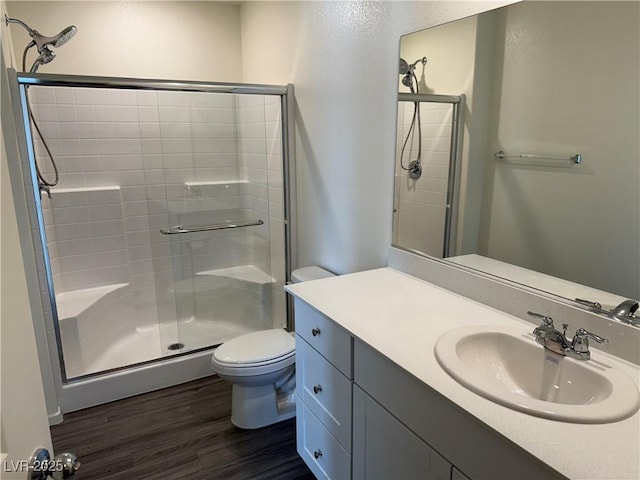 1906 Arietta Vista St, Henderson, NV 89044 - bathroom featuring wood finished floors, toilet, a shower stall, and vanity