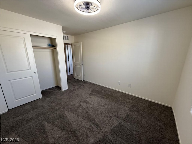 1906 Arietta Vista St, Henderson, NV 89044 - unfurnished bedroom featuring dark carpet, a closet, and baseboards