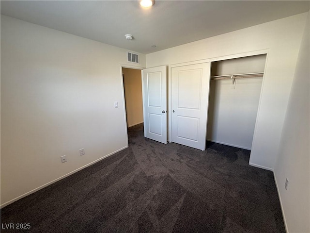 1906 Arietta Vista St, Henderson, NV 89044 - unfurnished bedroom featuring dark carpet, baseboards, and a closet