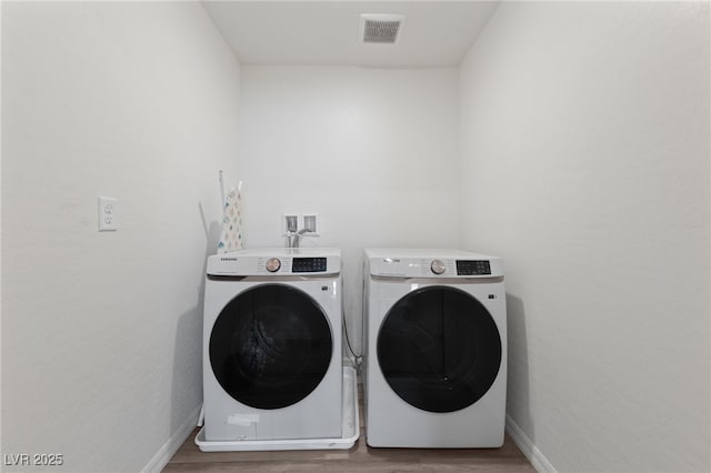 2729 Pavehawk Way, Las Vegas, NV 89156 - washroom featuring washer and clothes dryer and wood finished floors