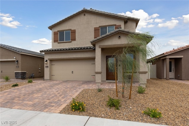 2729 Pavehawk Way, Las Vegas, NV 89156 - view of front of house featuring stucco siding, an attached garage, a tiled roof, and decorative driveway