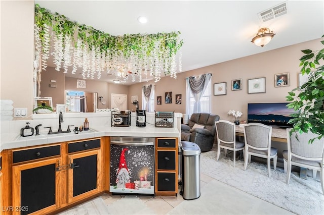 10701 Windrose Point Ave, Las Vegas, NV 89144 - bar featuring dishwashing machine, a sink, and light tile patterned floors