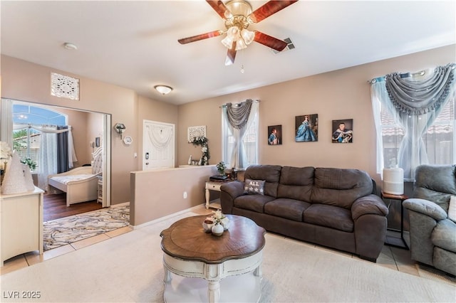 10701 Windrose Point Ave, Las Vegas, NV 89144 - living area with plenty of natural light, a ceiling fan, and a baseboard radiator