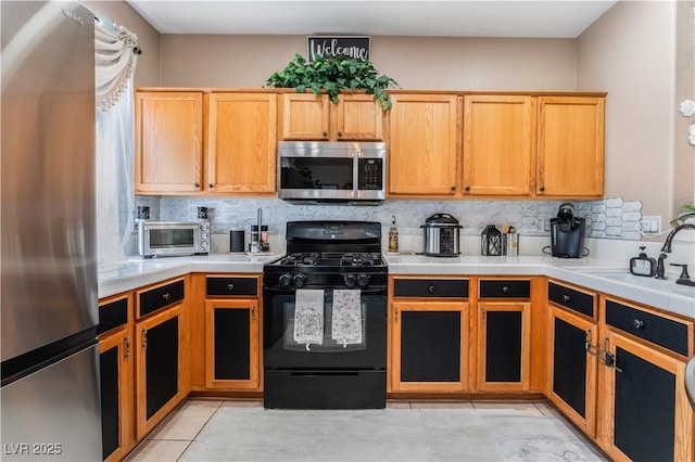 10701 Windrose Point Ave, Las Vegas, NV 89144 - kitchen featuring appliances with stainless steel finishes, a sink, tasteful backsplash, and tile counters