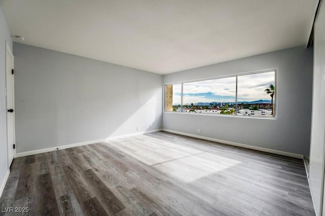 745 N Royal Crest Cir Unit 141, Las Vegas, NV 89169 - unfurnished room featuring wood finished floors, baseboards, and a smoke detector