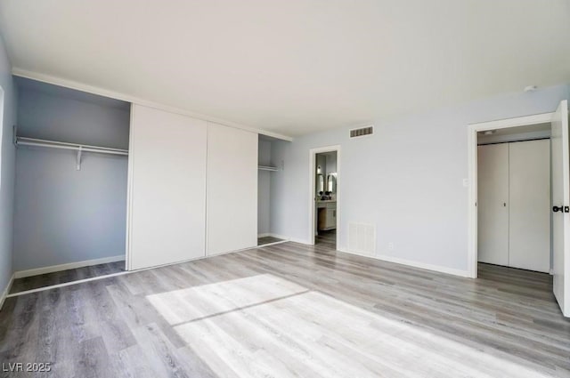 745 N Royal Crest Cir Unit 141, Las Vegas, NV 89169 - unfurnished bedroom with light wood-style flooring and baseboards