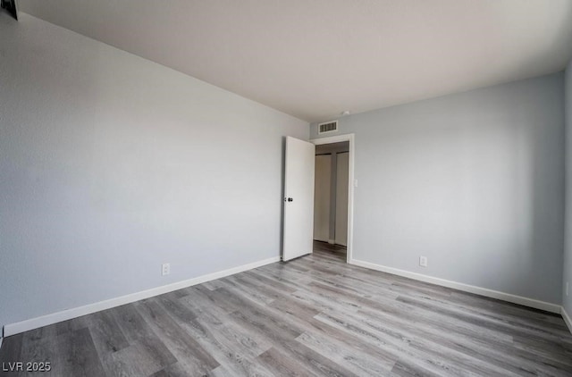 745 N Royal Crest Cir Unit 141, Las Vegas, NV 89169 - unfurnished bedroom featuring wood finished floors and baseboards