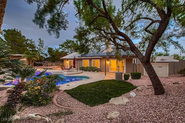 outdoor pool with a patio area and fence