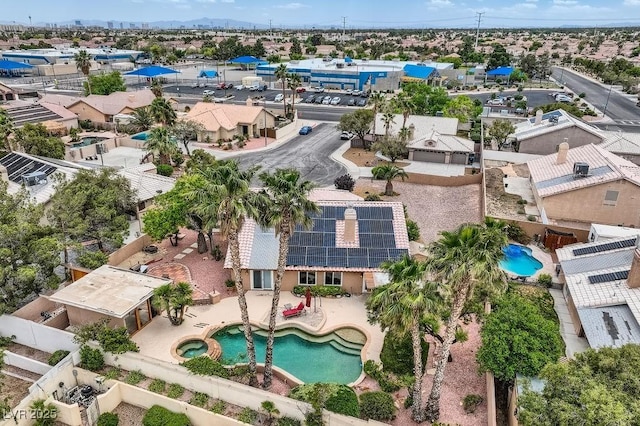 aerial perspective of suburban area featuring a pool area