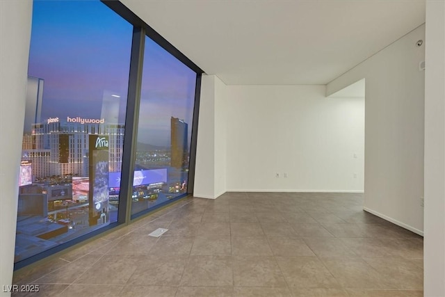 3726 Las Vegas Blvd Unit 1902, Las Vegas, NV 89158 - empty room with tile patterned flooring, floor to ceiling windows, and baseboards