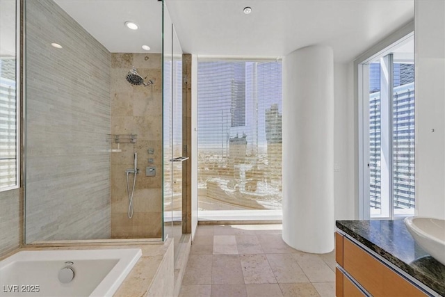 3726 Las Vegas Blvd Unit 1902, Las Vegas, NV 89158 - bathroom with vanity, tiled shower, plenty of natural light, and tiled bath